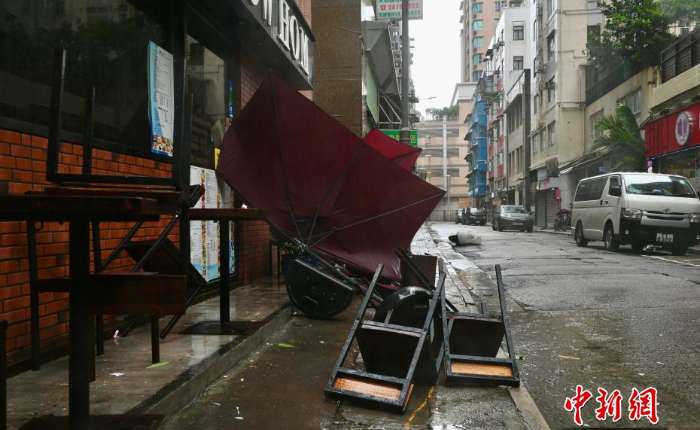 图为一家店铺的户外桌椅被吹倒。
