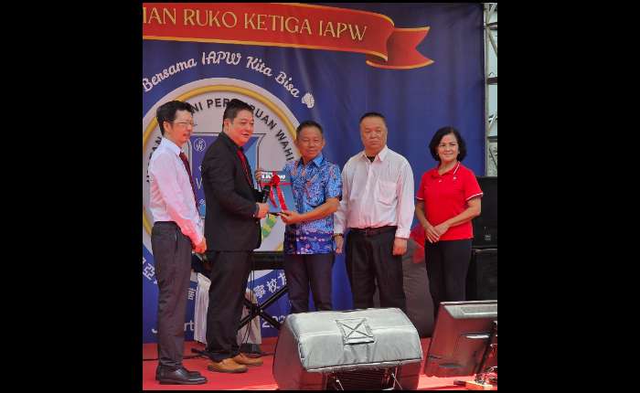 李汉湘（左二）代表1977年届同学会赠送记载IAPW创会历程纪念书籍给何清俊总主席